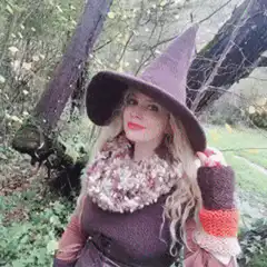 woman in witch hat posing in woods