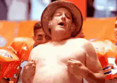 shirtless man in hat laughing