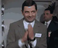 Mr. Bean clapping and smiling smugly