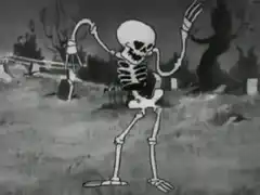 Skeleton dancing in graveyard