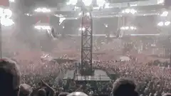 Crowd at a large concert with flashing lights