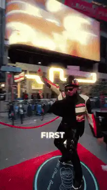 Man dancing on red carpet with text