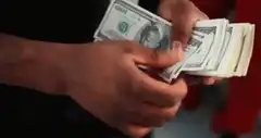 Hands counting hundred dollar bills