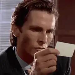 Bruce Wayne looks at a card