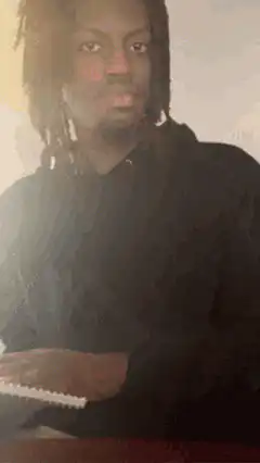 Man shows notebook then writes with pen