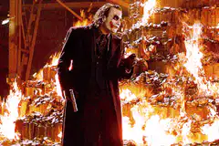 Joker laughs in front of fire