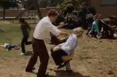 man shaking boy on spring rider