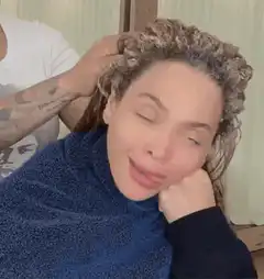 Woman getting hair done making funny face