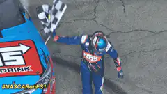 NASCAR driver celebrates with checkered flag