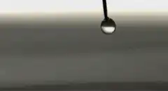 Water droplet hitting surface in slow motion