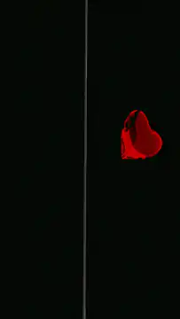 Red heart shatters into water droplets