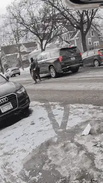 Soldier slips on ice in street