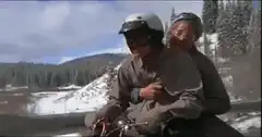 Old man riding motorcycle with young man