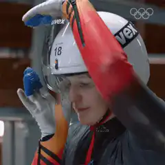 Bobsledder adjusts helmet visor