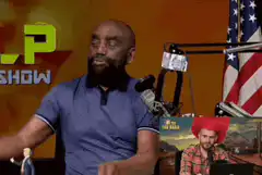 Man puts on MAGA hat and gives thumbs up