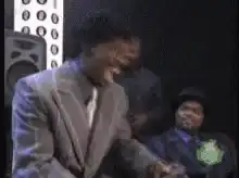 Man in suit laughing hysterically