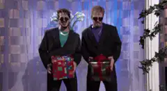 Two men in sunglasses holding gifts