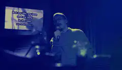 Man singing karaoke with lyrics on screen