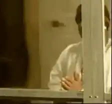 Man praying in window