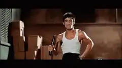 Bruce Lee flexing muscles