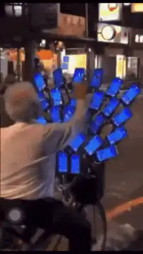 man on bike with many phones