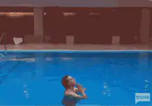 Elon Musk floating in a pool