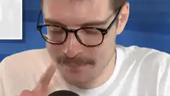 Man with mustache and glasses asks if mic is on