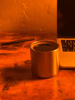 steaming metal cup on desk