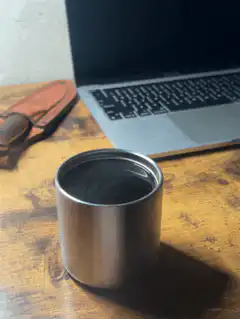 steaming metal cup on desk