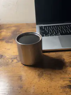 coffee cup next to laptop