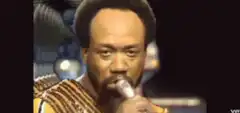 Bill Cosby singing into a microphone