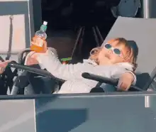 Toddler drinking juice in sunglasses