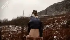 Woman doing a handstand in a field
