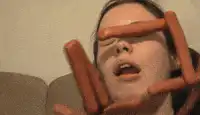 woman with hot dogs on face