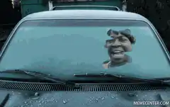 Woman laughing in car windshield