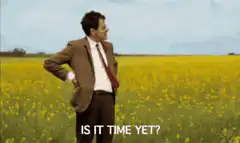 Man in field checking watch is it time yet