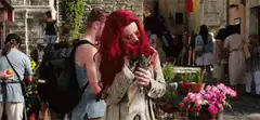 Woman smelling flowers and reacting