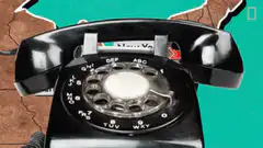 Black rotary phone on map