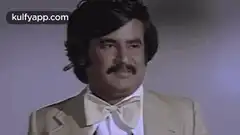 Man in suit raises hand