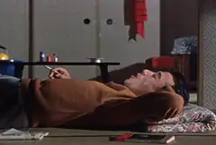 Man smoking on tatami mat