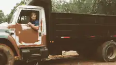 Man in old truck waving