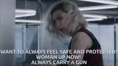 Woman with gun looking at camera