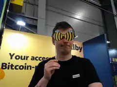 Man wearing bee sunglasses at Bitcoin event