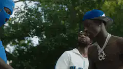 Shirtless man in blue cap shakes hands