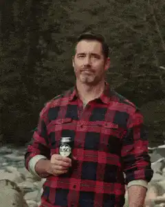Man in plaid shirt pointing finger