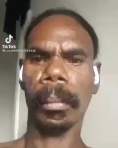 Man with mustache and earbuds