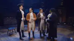 Hamilton cast toasting on stage