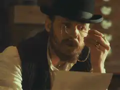 Man in top hat reads letter