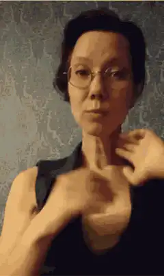 Woman doing hand gesture and smiling