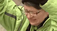 Man in green jacket screaming in frustration